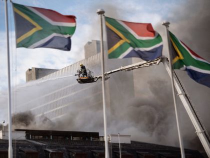 Firefighters are at work to extinguish a fire burning in the National Assembly, the main chamber of the South African Parliament buildings, on January 03, 2022, in Cape Town. (Photo by RODGER BOSCH / AFP) (Photo by RODGER BOSCH/AFP via Getty Images)