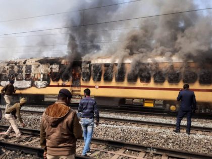 TOPSHOT - Smoke comes out from a train's carriage after angry mobs set it on fire in protests over access to railway jobs that have seen police violently disperse crowds with tear gas and baton charges, in Gaya, in the northeast Indian state of Bihar on January 26, 2022. (Photo …