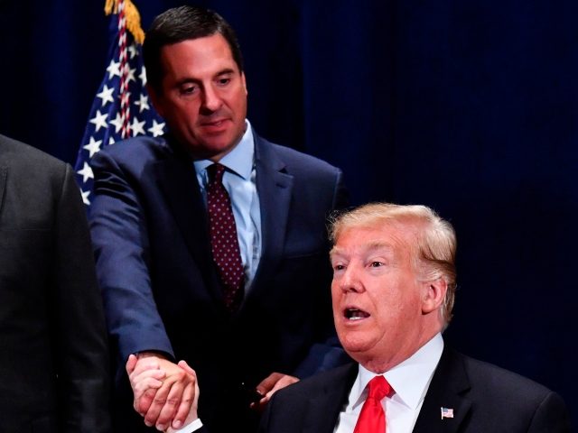 US President Donald Trump (C) shakes hands with US Representative Devin Nunes (R-CA) as House Majority Leader Kevin McCarthy (R-CA) (L) looks on after signing a presidential memorandum focused on sending more water to farmers in California's Central Valley, during a meeting in Scottsdale, Arizona, on October 19, 2018. (Photo …