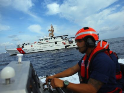 MIAMI BEACH, FL - OCTOBER 17: United States Coast Guard BM1 Christopher Valdes drives the 7.9-meter small boat alongside the United States Coast Guard Cutter William Flores on October 17, 2012 just off shore Miami Beach, Florida. The cutter is the third of a planned 58 Fast Response Cutters in …