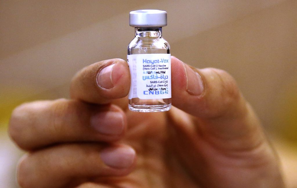 A health worker holds up a vial of the UAE-made "Hayat-Vax" COVID-19 coronavirus vaccine, a locally-produced version of China's Sinopharm vaccine, at a vaccination centre set up inside a school in Iran's capital Tehran on October 7, 2021. (Photo by AFP) (Photo by -/AFP via Getty Images)