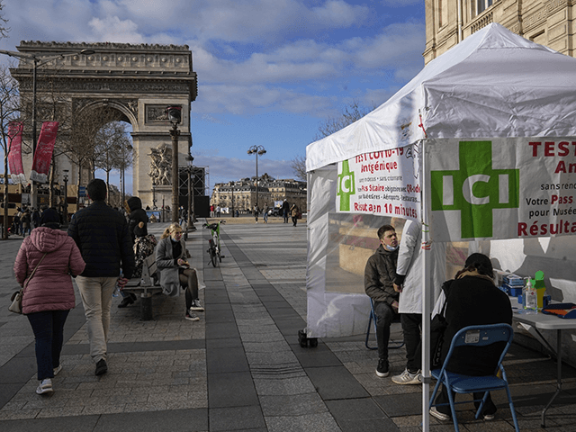 A man gets a nasal swap at a mobile COVID-19 testing site at the Champs Elysees avenue in