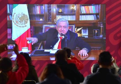 Mexican President Andres Manuel Lopez Obrador checks his blood oxygen level during an appearance by video link on January 11, 2022, a day after announcing he had caught Covid-19 for a second time