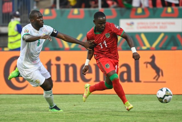 Senegal captain Kalidou Koulibaly (L) chases Malawi forward Gabadinho Mhango during an Af
