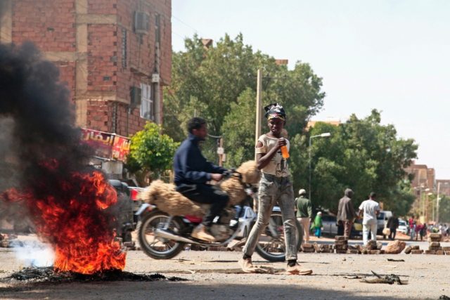Sudanese demonstrators barricade a street in Khartoum Tuesday amid ongoing protests agains