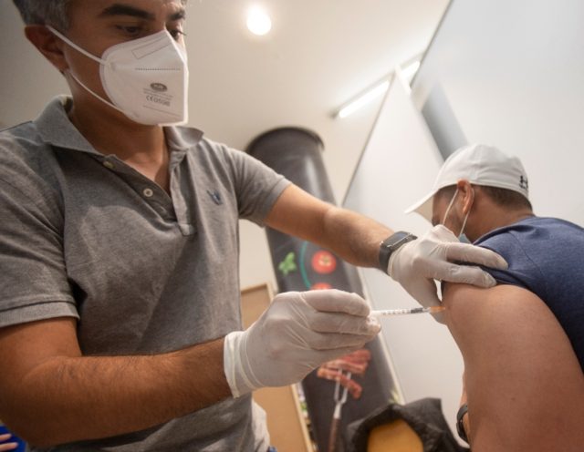 A man gets a Covid-19 jab at a vaccination station in Vienna on August 25, 2021; from Febr