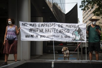 People take part in a demonstration against the Spanish oil company Repsol in Lima, on Jan