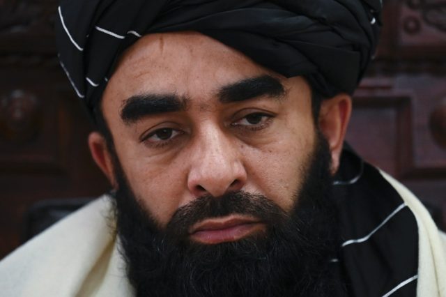 Taliban spokesman Zabihullah Mujahid listens to questions during an interview with AFP in