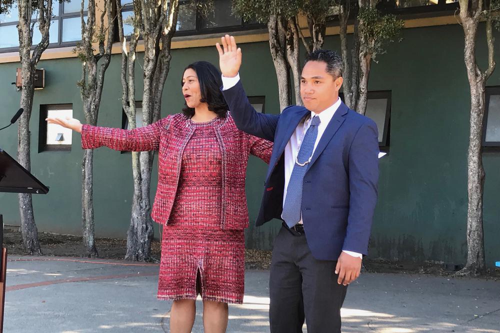San Francisco Mayor London Breed, left, waves next to Faauuga Moliga, who she appointed to the school board, Oct. 15, 2018, in San Francisco. In a city with the lowest percentage of children of all major American cities, school board elections in San Francisco have often been an afterthought. A special election on Feb. 15, 2022, will decide the fate of three school board members, all Democrats, including Moliga, in a vote that has divided the famously liberal city. (Jill Tucker/San Francisco Chronicle via AP)