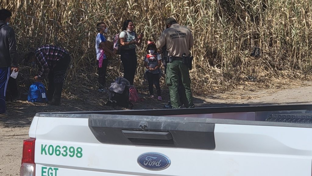 Texas National Guard soldiers detain two migrant family groups until Border Patrol agents arrive to process them. (Bob Price/Breitbart Texas)