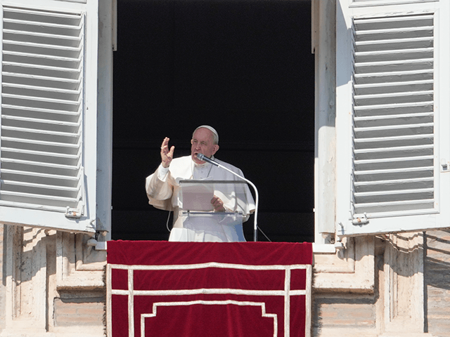 Pope Francis delivers the Angelus noon prayer from his studio window overlooking St. Peter