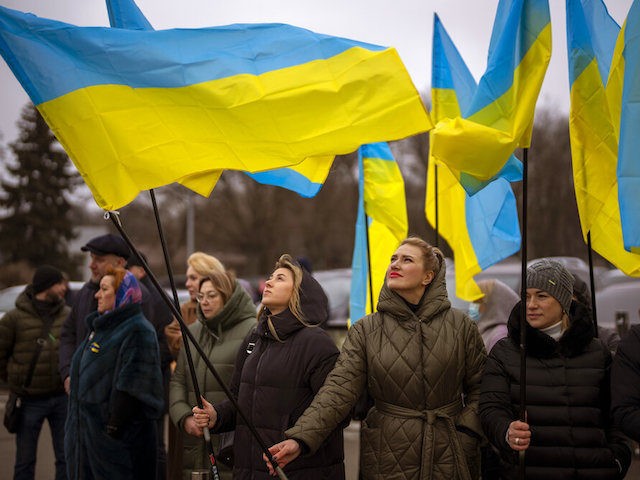 Women hold Ukrainian flags as they gather to celebrate a Day of Unity in Odessa, Ukraine,