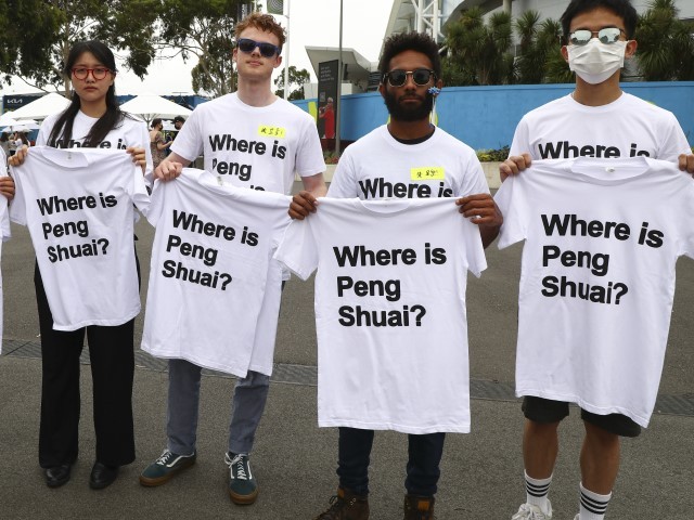 Supporters of Chinese tennis player Peng Shuai hold up T-shirts ahead of the women's final at the Australian Open tennis championships in Melbourne, Australia, Saturday, Jan. 29, 2022. Peng, the former No. 1- ranked doubles player who won titles at Wimbledon and the French Open, dropped out of public view in November after accusing a former high-ranking Chinese government official, vice premier Zhang Gaoli, of sexual assault.