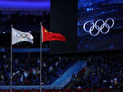 he IOC and Chinese flag are seen flying next to each other during the Opening Ceremony of the Beijing 2022 Winter Olympics at the Beijing National Stadium on February 04, 2022 in Beijing, China. (Photo by Lintao Zhang/Getty Images)