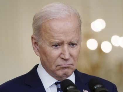 President Joe Biden listens to questions from reporters while speaking about the Russian i