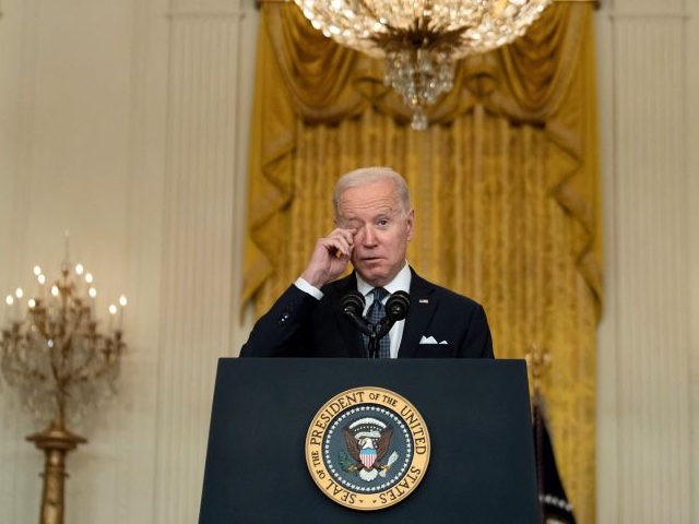 US President Joe Biden rubs his eye while speaking in the East Room of the White House abo
