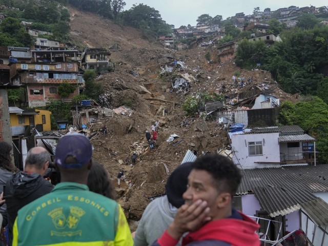Rescue workers and residents look for victims in an area affected by landslides in Petropolis, Brazil, Wednesday, Feb. 16, 2022.