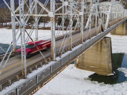 People drive on the Nanticoke/West Nanticoke Bridge in West Nanticoke, Pennsylvania, over the icy Susquehanna River on Tuesday, January 18, 2022. The Pennsylvania Department of Transportation rates the bridge's overall condition as poor. Thousands of people a day drive over the structure, which the Eastern Steel Co. constructed in 1914.