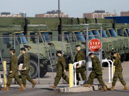 TORONTO, ON - APRIL 06: Members of the Canadian Forces head to their vehicles at Denison Armory to convoy to CFB Borden amid the spread of the coronavirus disease (COVID-19) on April 6, 2020 in Toronto, Canada. Troops will remain ready to respond to any requests made by any levels …