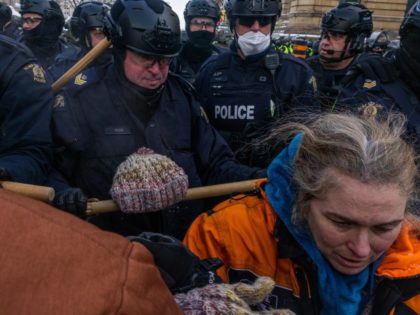 OTTAWA, ONTARIO - FEBRUARY 19: Police face off with demonstrators participating in a protest organized by truck drivers opposing vaccine mandates on Wellington St. on February 19, 2022, in Ottawa, Ontario. The drivers have used vehicles to form a blockade that has blocked several streets near Parliament Hill. Prime Minister …