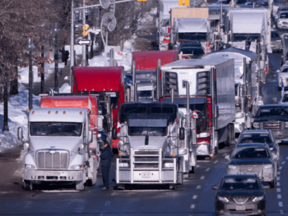 Vehicles from the protest convoy are parked blocking lanes on a road, Sunday, Jan. 30, 2022 in Ottawa. Residents of the national capital are again being told to avoid traveling downtown as a convoy of trucks and cars snarl traffic protesting government-imposed vaccine mandates and COVID-19 restrictions. (Adrian Wyld/The Canadian …