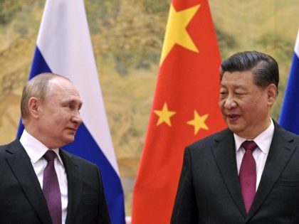 Chinese President Xi Jinping, right, and Russian President Vladimir Putin talk to each other during their meeting in Beijing, China, Friday, Feb. 4, 2022. Russian President Vladimir Putin is in Beijing for the Winter Olympics and talks with his Chinese counterpart Xi Jinping, amid soaring tensions with Ukraine.