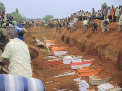Civilians and Red Cross volunteers attend on February 4, 2022 the burial of 62 displaced people who were massacred on the night of February 1, 2022 in the Plaine Savo IDP camp near Bule in Ituri province, northeastern Democratic Republic of Congo. - This massacre is attributed by the authorities …