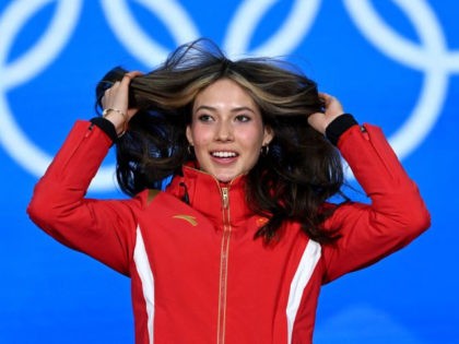 Gold medallist China's Gu Ailing Eileen gestures on the podium during the freestyle s