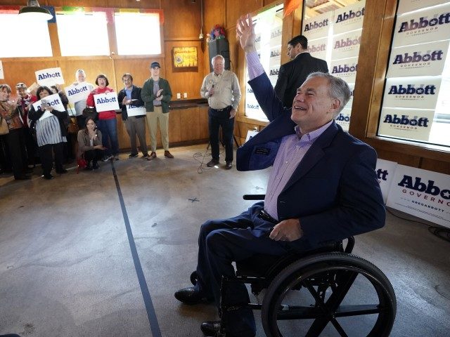 Texas Gov. Greg Abbott, right, greets supporters during a campaign stop, Thursday, Feb. 17