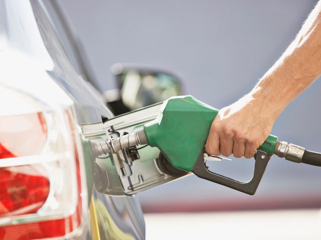 Filling vehicle with gas - stock image. (Tom Merton/Getty Images Stock Photo)
