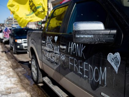 LANSING, MI - FEBRUARY 20: Cars line up to participate in a Freedom Convoy protesting Covid restrictions and demanding election audits on February 20, 2022 in Lansing, Michigan. The Freedom Convoy has been circling the Michigan State Capitol daily while simultaneously honking horns in support of ongoing protests in Canada.