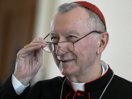 Vatican Secretary of State Cardinal Pietro Parolin holds his glasses as he is welcomed by German President Frank-Walter Steinmeier for a meeting at the Bellevue palace in Berlin, Germany, Tuesday, June 29, 2021.
