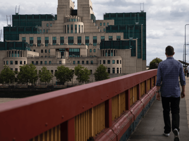 LONDON, ENGLAND - AUGUST 17: A man walks over Vauxhall Bridge towards the MI6 headquarters