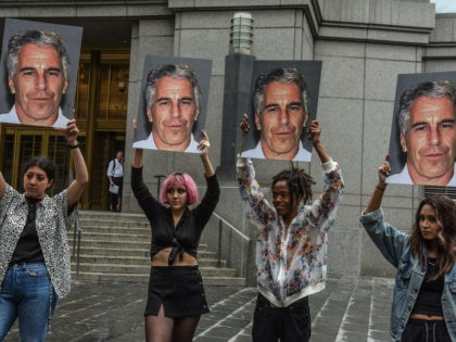 NEW YORK, NY - JULY 08: A protest group called "Hot Mess" hold up signs of Jeffrey Epstein in front of the Federal courthouse on July 8, 2019 in New York City. According to reports, Epstein will be charged with one count of sex trafficking of minors and one count …