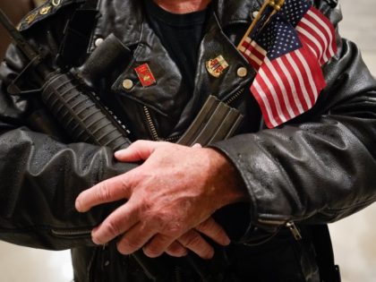 FRANKFORT, KY - JANUARY 31: Calvin Pinkston, 61, of Louisville, Ky., stands in the rotunda of the State Capitol holding a semi-autoimaric rifle on January 31, 2020 in Frankfort, Kentucky. Open carry of loaded firearms is permitted throughout the Capitol, except in the chambers of the Supreme Court. Advocates from …