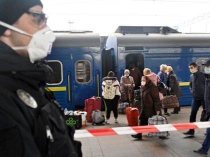 Ukrainians who were evacuated from Moscow, leave their train carriages after pulling in fr