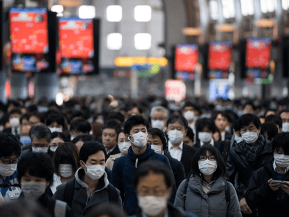 Commuters wearing face masks make their way to work on March 26, 2020 in Tokyo, Japan. Tokyo Governor Yuriko Koike held a press conference last night to request citizens to refrain from going outside this weekend for nonessential reasons after 41 cases of new coronavirus infections were confirmed yesterday. She …