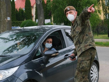 CZERWINSK NAD WISLA, POLAND - MAY 28: A military wears a protective mask as he gives instr