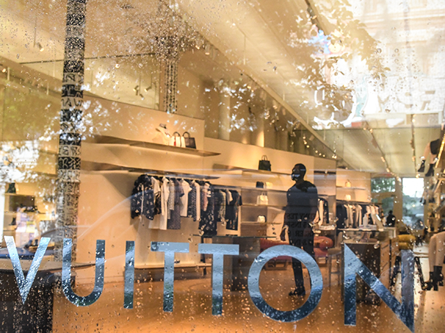 A worker stands inside of a Louis Vuitton store on June 22, 2020 in the SoHo neighborhood