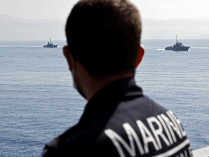 A French navy officer look on from the French warship stealth frigate La Fayette during a