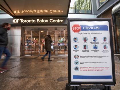People arrive at the entrance to the Toronto Eaton Centre in downtown Toronto, Ontario on November 23, 2020, the first day of a new lockdown in the city. - Canada's largest city Toronto and much of its suburbs will be placed under lockdown beginning November 23 due to the spread …