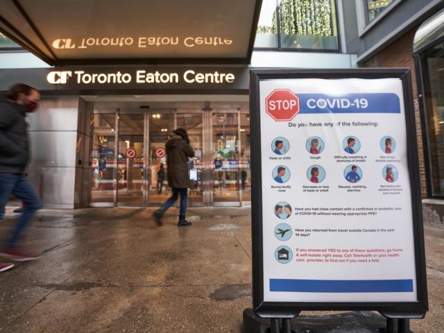 People arrive at the entrance to the Toronto Eaton Centre in downtown Toronto, Ontario on