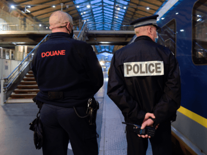 A French Border Police officer (L) and a National Police officer stand near an Eurostar train in Gare du Nord station in Paris on December 10, 2020. (Photo by ERIC PIERMONT / AFP) (Photo by ERIC PIERMONT/AFP via Getty Images)