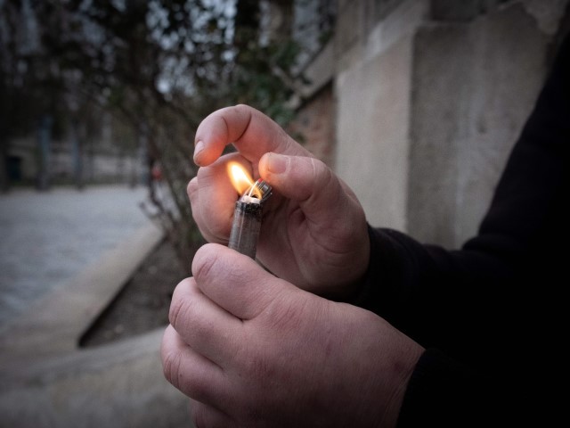 Malika, a crack addict lights a pipe at Stalingrad Square, nicknamed Stalincrack, on December 2, 2020 in Paris. - This "drug of the poor" has been wreaking havoc in the north-east of the capital for thirty years. Over the past 18 months, the authorities have been stepping up initiatives to try to curb the use of this smokable derivative of cocaine: reinforced police patrols, arrests of traffickers, accommodation for drug addicts but these efforts have so far been largely unsuccessful.