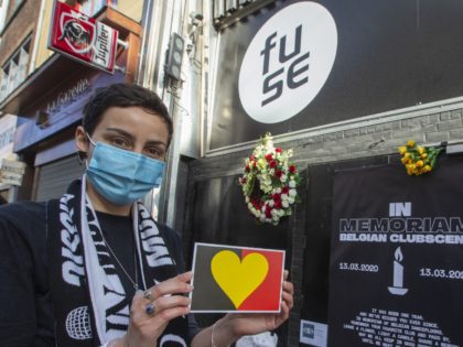 Illustration picture shows flowers and an 'In Memorian' sign for the Belgian Clubscene at the entrance to Brussels' night club The Fuse during A symbolic moment of remembrance of the nightclubs one year after the closure, in Brussels, Saturday 13 March 2021. Twenty-five nightclub and discotheque owners from Flanders and …