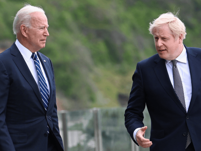 CARBIS BAY, ENGLAND - JUNE 10: Britain's Prime Minister Boris Johnson speaks with U.S. President Joe Biden while they walk with their wives, Carrie Johnson, (not pictured) and U.S. First Lady Jill Bidenn, (not pictured), outside Carbis Bay Hotel, on June 10, 2021 near St Ives, England. UK Prime Minister, …