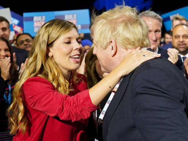 MANCHESTER, ENGLAND - OCTOBER 06: Carrie Johnson greets her husband Boris Johnson before