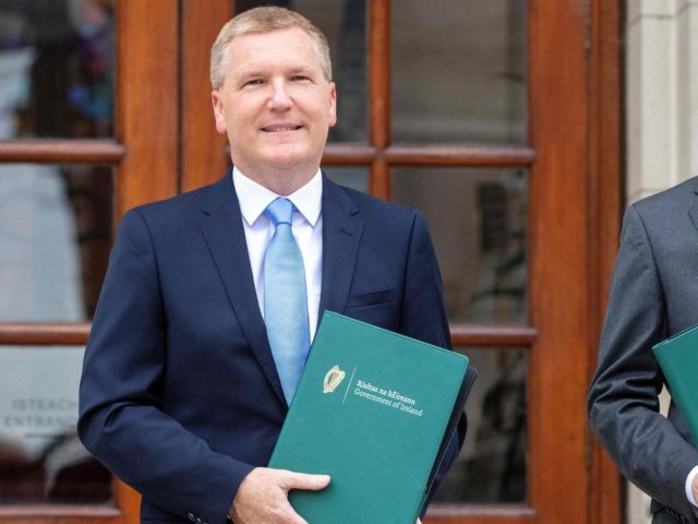 Ireland's Finance Minister Paschal Donohoe (R) poses with Ireland's Minister for Public Ex