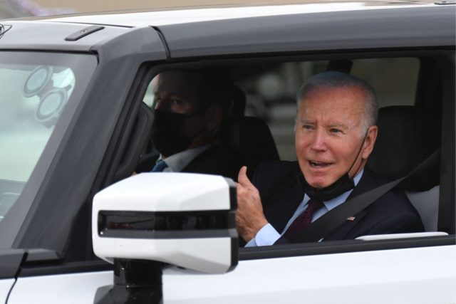 US President Joe Biden test drives an electric hummer as he tours the General Motors Facto