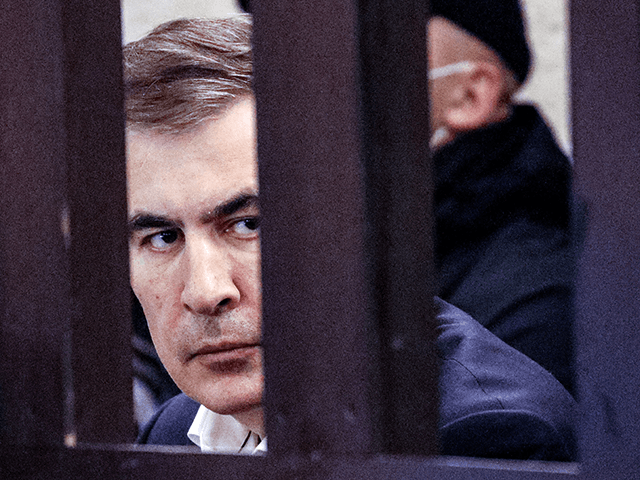 Georgian former President Mikheil Saakashvili sits in the defendant's box during his trial